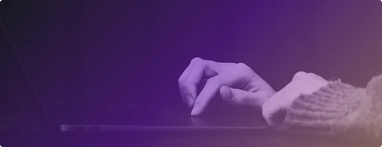 Photo of hands on a laptop with purple gradient filter