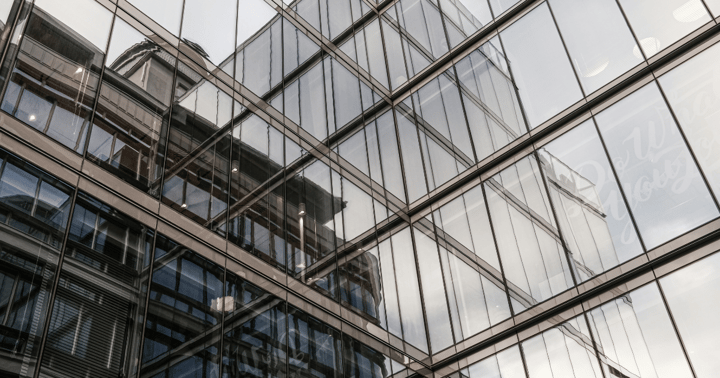 Photograph of a glass building taken from below