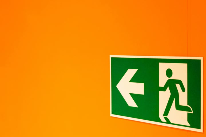 Image of an exit sign on an orange wall