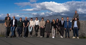 Photo of the Aftra team standing in front of mountain