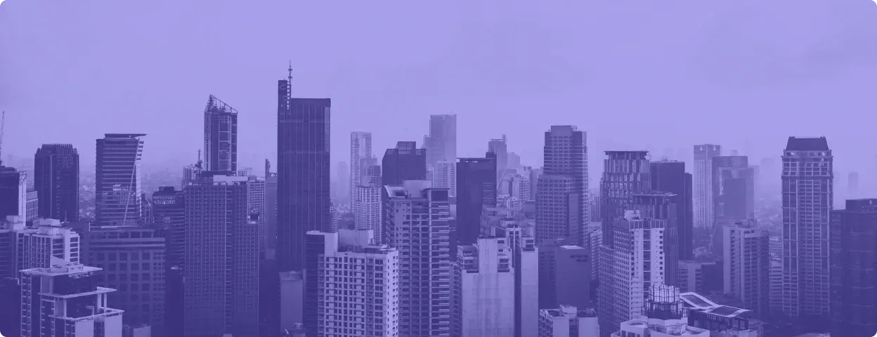 Photo of a city skyline with a purple filter on it