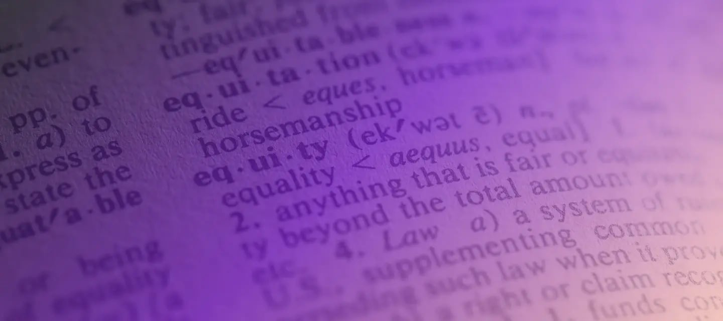 Up close photograph of a dictionary entry with a purple gradient filter