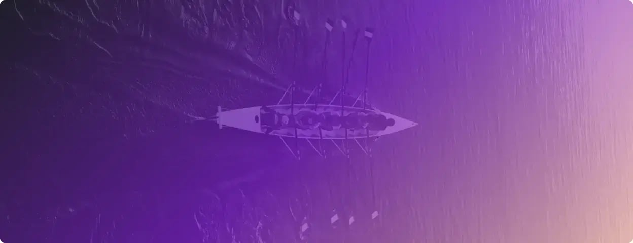 Photograph of people rowing a boat taken from above