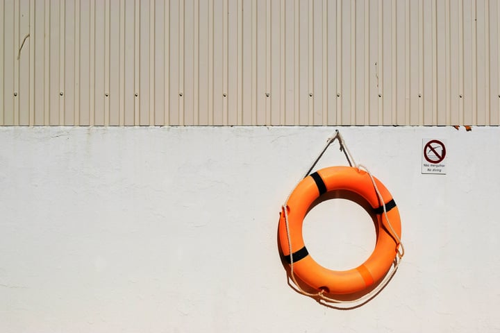 Photo of a lifebouy hanging on a wall