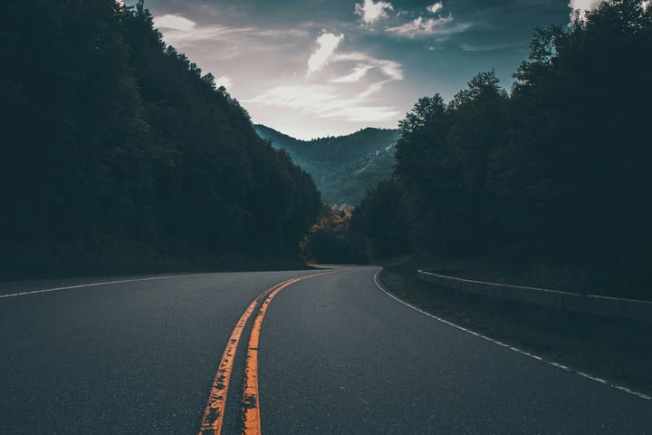 Photo of a road going through the mountains